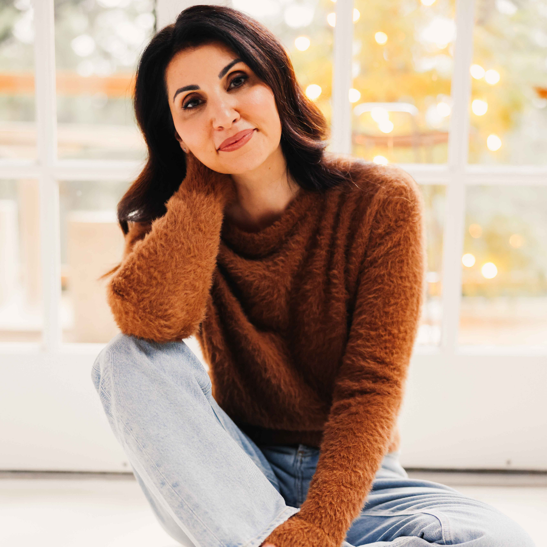 Maria Fabiano sitting by a window, smiling